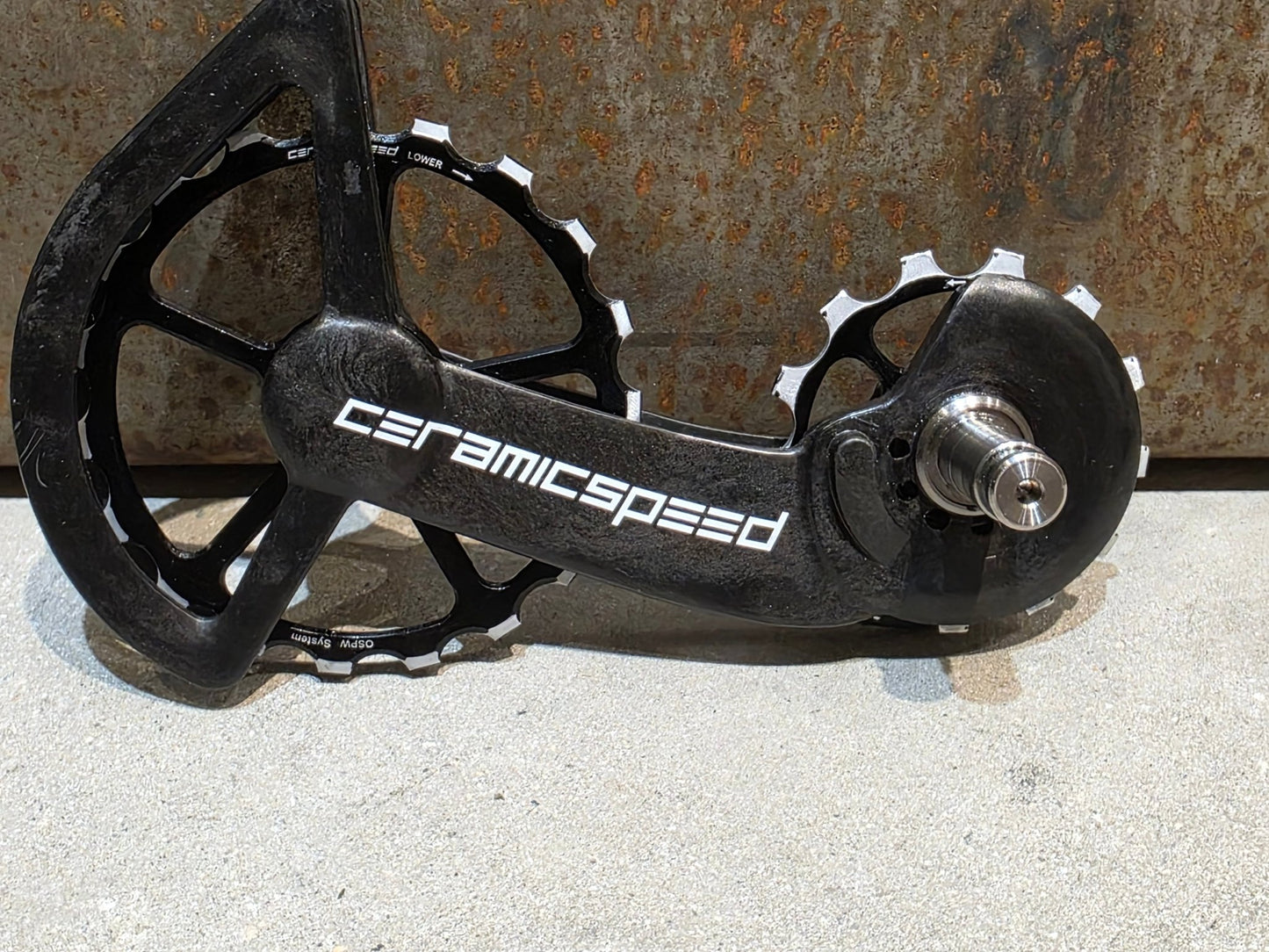 Schaltungsteile von Ceramicspeed, CERAMICSPEED OSPW COATED SHIMANO R9100 DURA ACE / R8000 ULTEGRA vor USEDBIKES - OB.DE Hintergrund