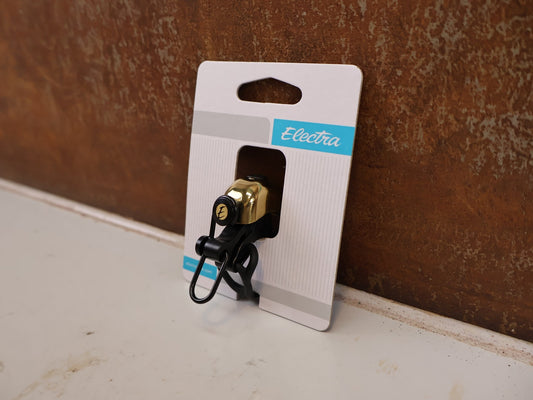 Sonstiges von Electra, ELECTRA PINGER FAHRRADKLINGEL GOLD MESSING POLIERT 90 DB vor USEDBIKES-OB.DE Hintergrund