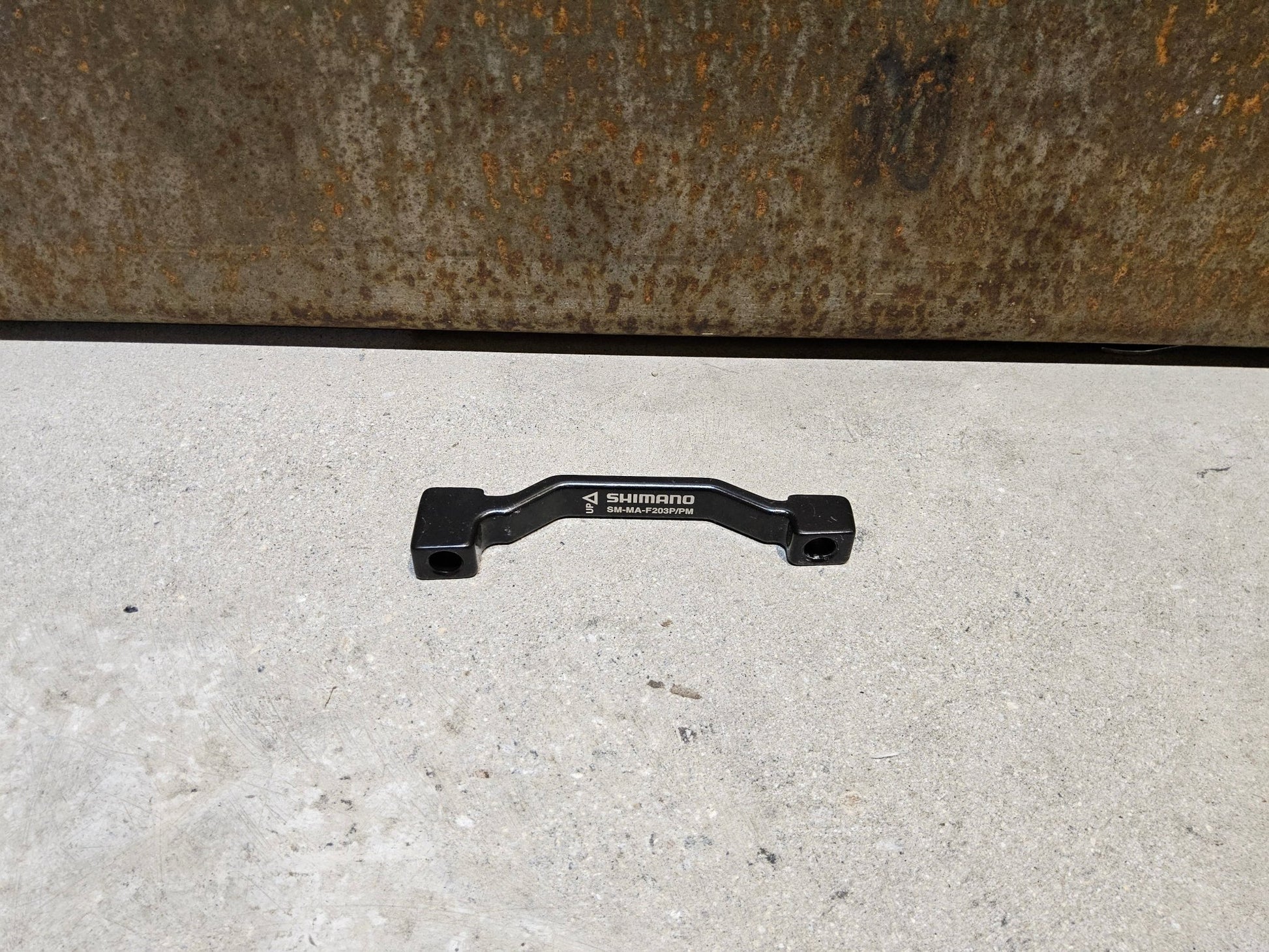 Zubehör von Shimano, SHIMANO ADAPTER POSTMOUNT 203MM / VORNE O. HINTEN vor USEDBIKES - OB.DE Hintergrund