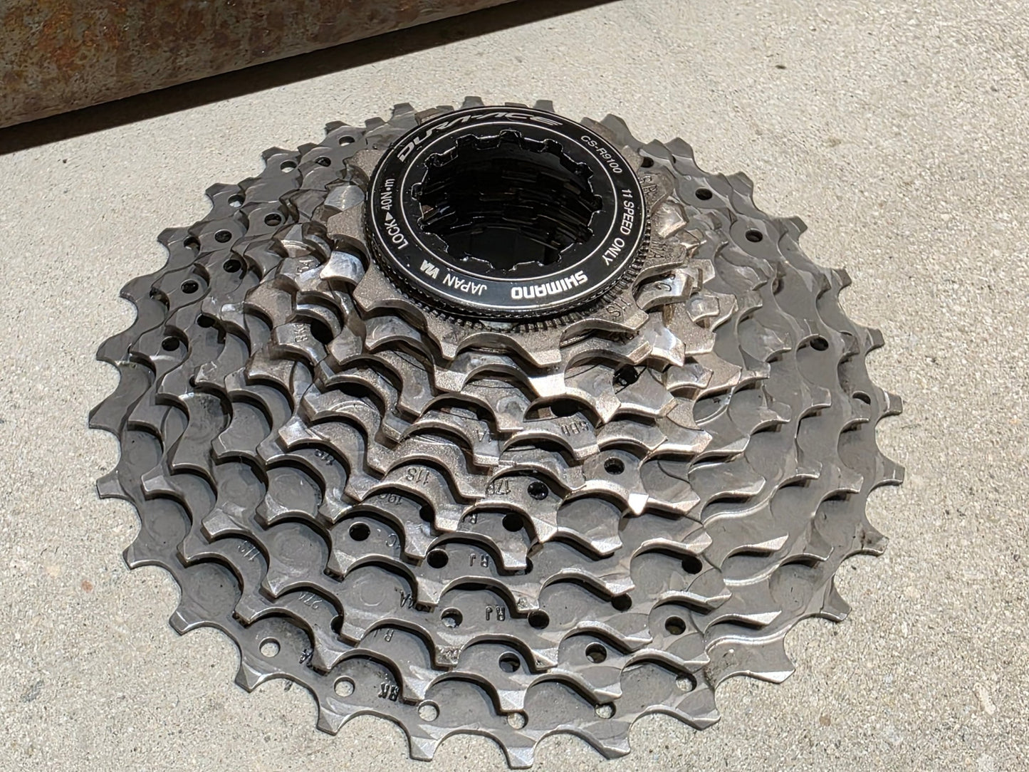 Kassette & Zahnkränze von Shimano, SHIMANO DURA ACE KASSETTE CS - R9100 11 - 30 ZAHNKRANZ vor USEDBIKES - OB.DE Hintergrund