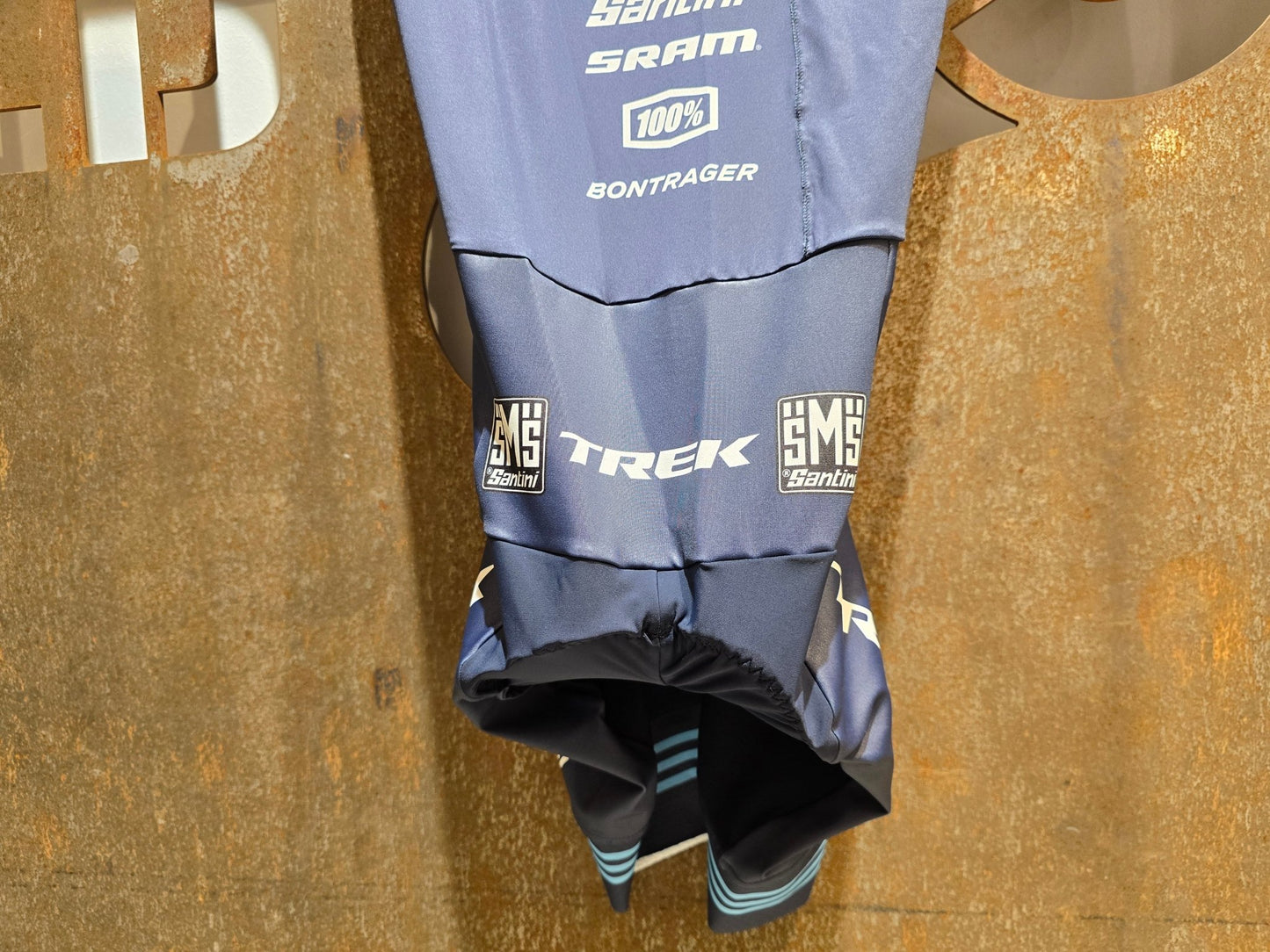 Damenbekleidung - TFR von Santini, TREK FACTORY RACING CX / CX SUIT SHORTSLEEVE SUPERLIGHT W. PKT / EINTEILER / DAMEN in variant_title vor USEDBIKES - OB.DE Hintergrund