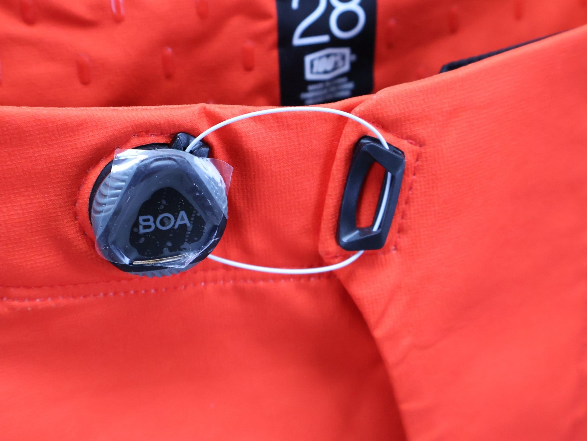 Hosen Herren von 100%, 100% – R - CORE X PANTS / ORANGE - RED / TREK FACTORY RACING TEAM / 4 - WAY STRETCH vor USEDBIKES - OB.DE Hintergrund