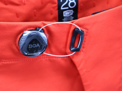 Hosen Herren von 100%, 100% – R - CORE X PANTS / ORANGE - RED / TREK FACTORY RACING TEAM / 4 - WAY STRETCH vor USEDBIKES - OB.DE Hintergrund