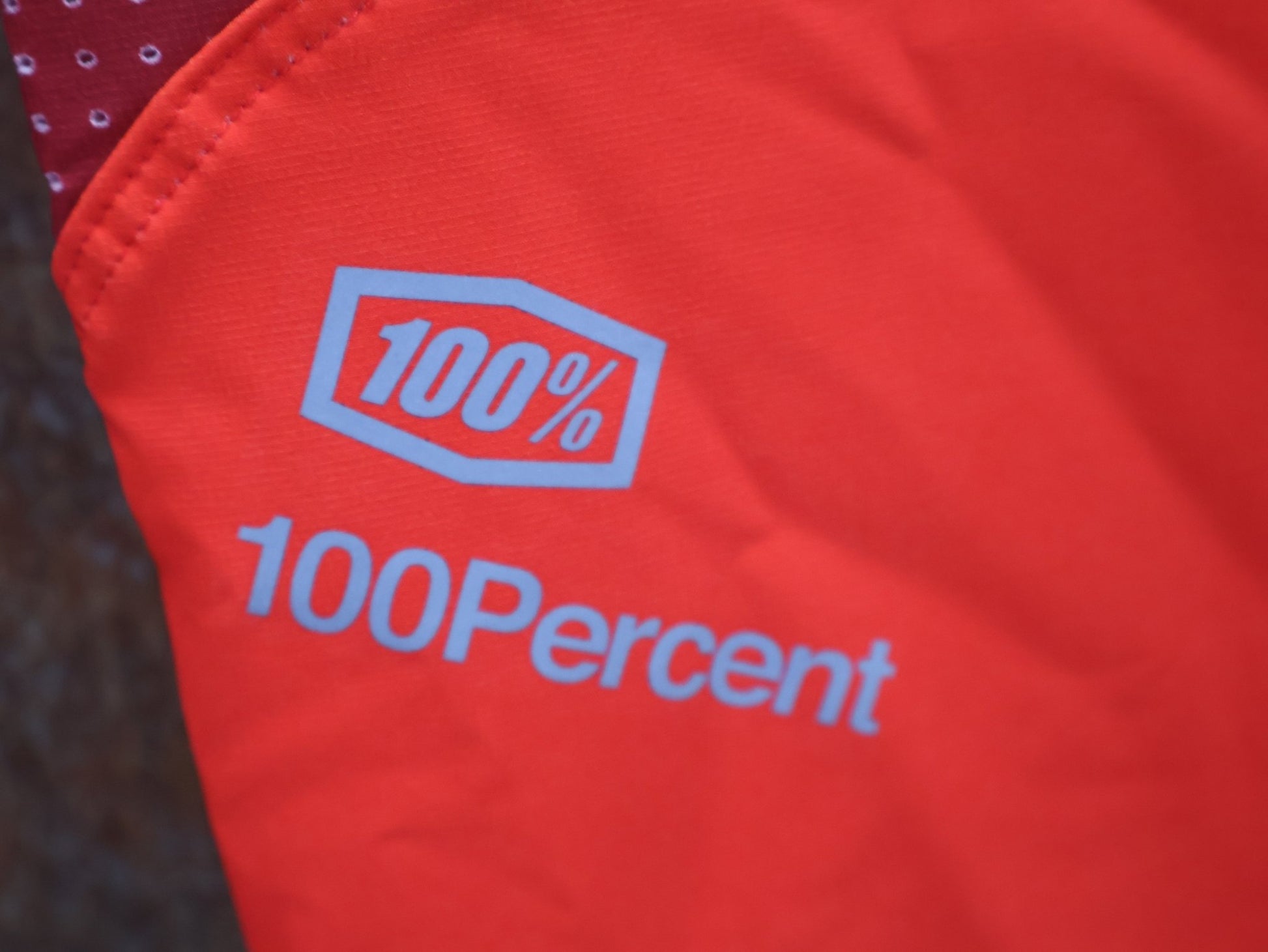 Hosen Herren von 100%, 100% – R - CORE X PANTS / ORANGE - RED / TREK FACTORY RACING TEAM / 4 - WAY STRETCH vor USEDBIKES - OB.DE Hintergrund