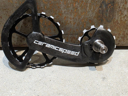 Schaltungsteile von Ceramicspeed, CERAMICSPEED OSPW COATED SHIMANO R9100 DURA ACE / R8000 ULTEGRA vor USEDBIKES - OB.DE Hintergrund