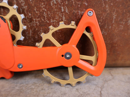 Schaltungsteile von Ceramicspeed, CERAMICSPEED OSPW X FÜR SRAM EAGLE AXS – COATED / ORANGE–BRONZE CERAKOTE vor USEDBIKES - OB.DE Hintergrund