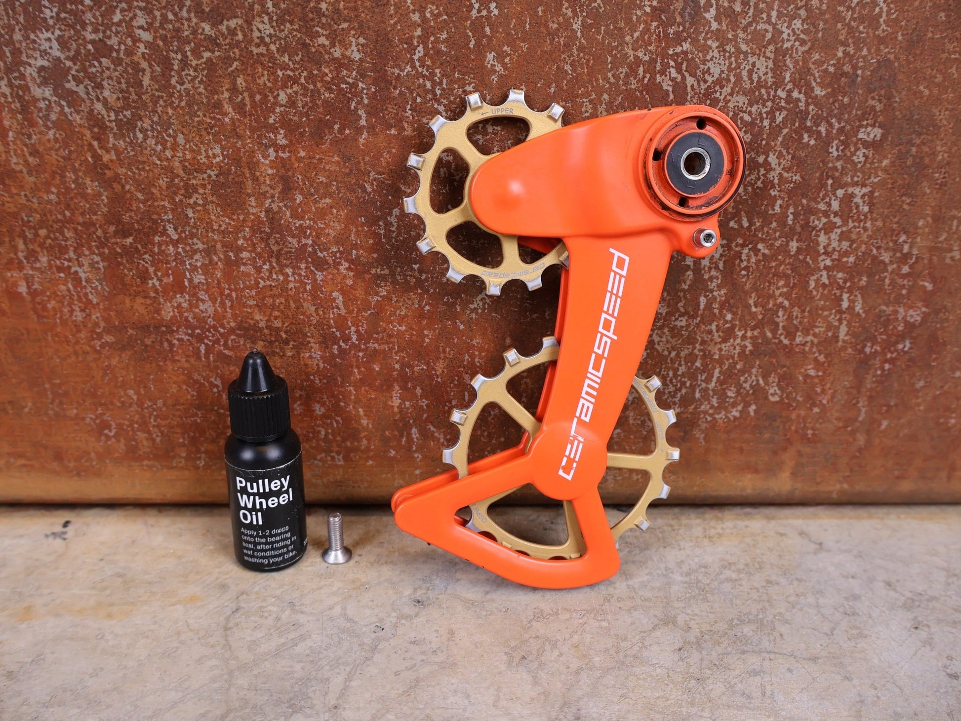 Schaltungsteile von Ceramicspeed, CERAMICSPEED OSPW X FÜR SRAM EAGLE AXS – COATED / ORANGE–BRONZE CERAKOTE vor USEDBIKES - OB.DE Hintergrund