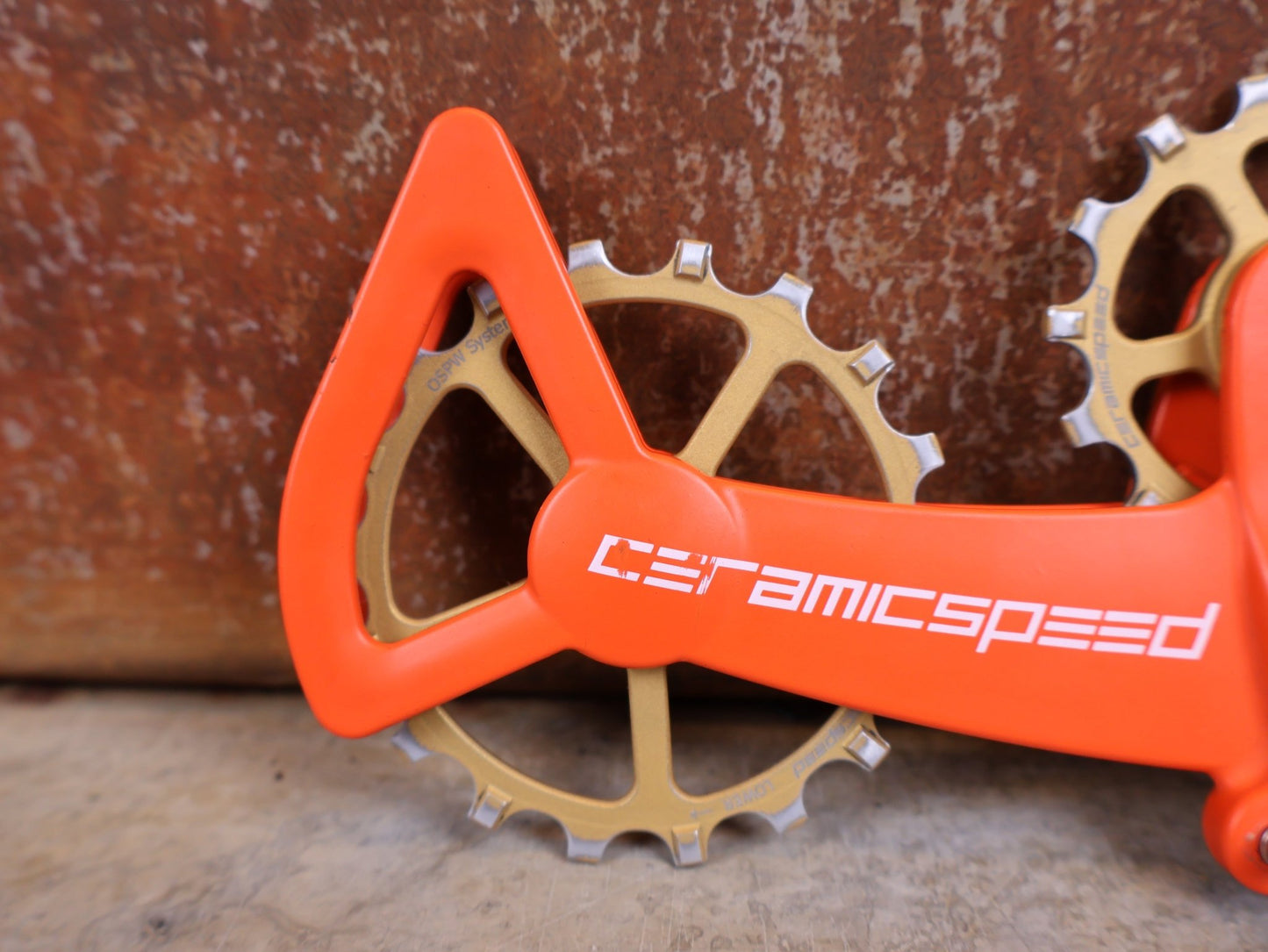 Schaltungsteile von Ceramicspeed, CERAMICSPEED OSPW X FÜR SRAM EAGLE AXS – COATED / ORANGE–BRONZE CERAKOTE vor USEDBIKES - OB.DE Hintergrund