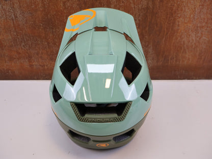 Helme von Endura, ENDURA SINGLETRACK / MIPS FULLFACE HELM / GR. L-XL 58-63 CM / OLIVGRÜN vor USEDBIKES-OB.DE Hintergrund