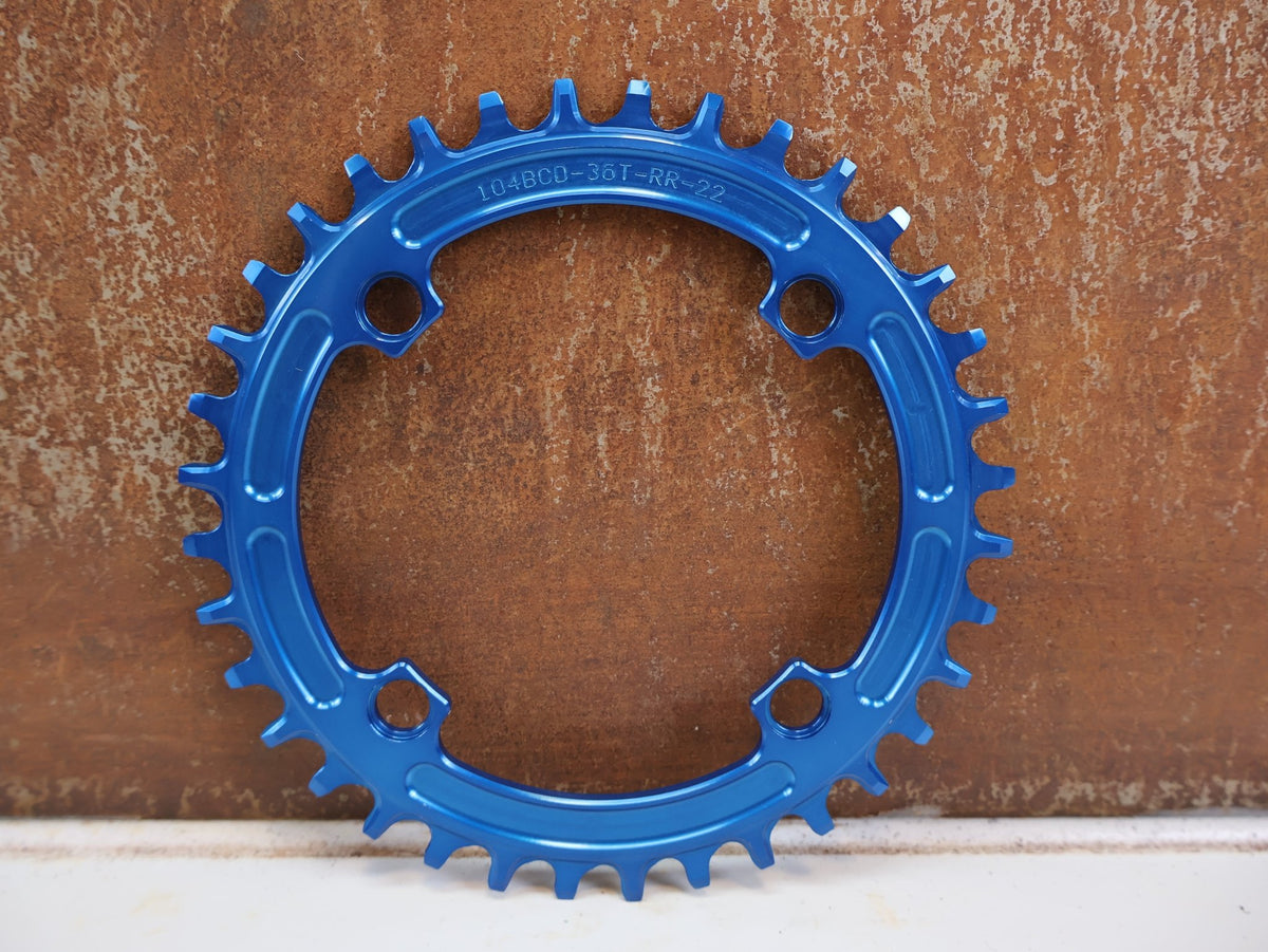 Kettenblatt von Hope, HOPE KETTENBLATT 104 BCD 36 ZÄHNE BLAU 4-ARM RR3622B vor USEDBIKES-OB.DE Hintergrund