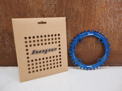 Kettenblatt von Hope, HOPE KETTENBLATT 104 BCD 36 ZÄHNE BLAU 4-ARM RR3622B vor USEDBIKES-OB.DE Hintergrund