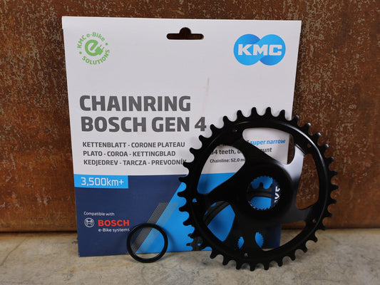 Kettenblatt von Kmc, KMC BOSCH GEN 4 E - BIKE KETTENBLATT 34T – 11/128" / 52 MM KETTENLINIE / CRMO vor USEDBIKES - OB.DE Hintergrund