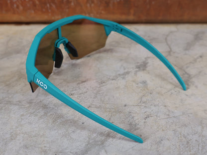 Brillen von Koo, KOO ALIBI BRILLE – PERSIAN GREEN MATT / ORANGE MIRROR vor USEDBIKES - OB.DE Hintergrund