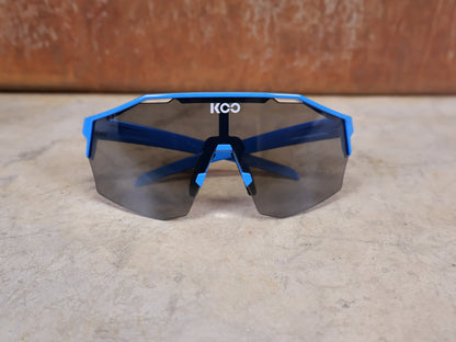 Brillen von Koo, KOO RED BULL - BORA HANSGROHE ALIBI PRO SONNENBRILLE / BLUE JERSEY vor USEDBIKES - OB.DE Hintergrund