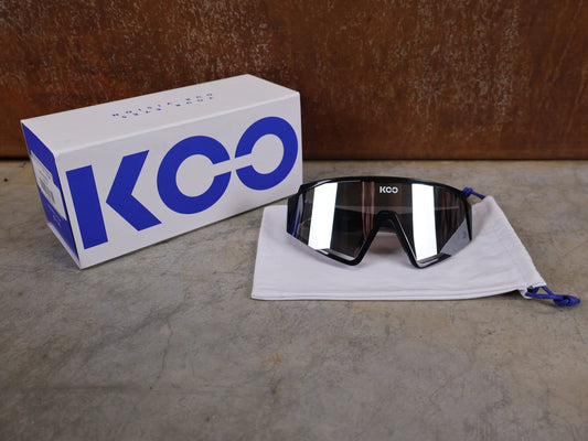 Brillen von Koo, KOO RED BULL - BORA HANSGROHE SPECTRO SONNENBRILLE / SCHWARZ GLANZ vor USEDBIKES - OB.DE Hintergrund