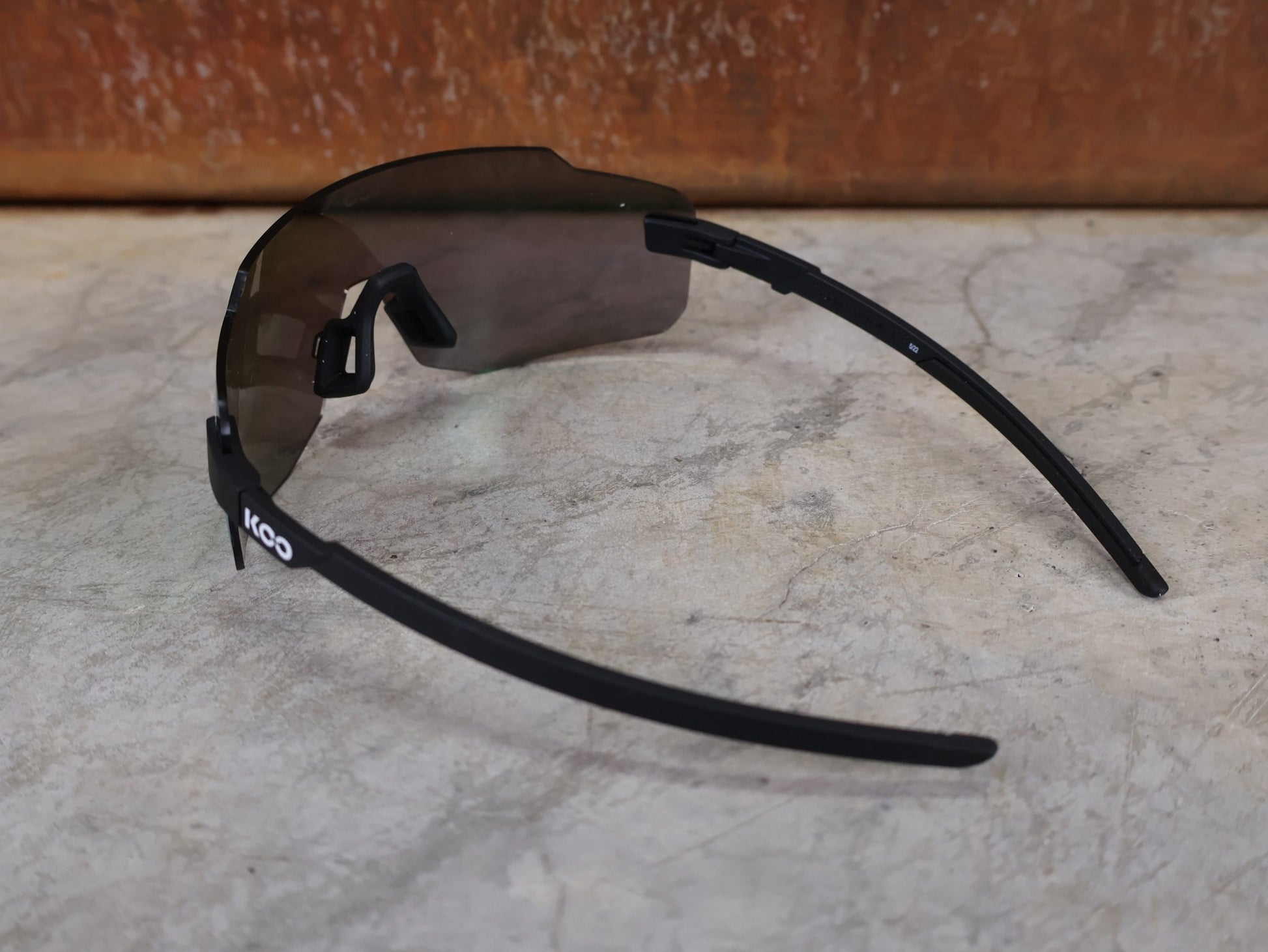 Brillen von Koo, KOO SUPERNOVA SONNENBRILLE / BLACK MATT GREEN MIRROR vor USEDBIKES - OB.DE Hintergrund