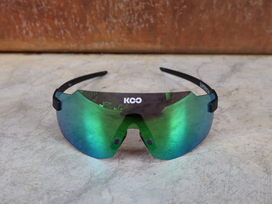 Brillen von Koo, KOO SUPERNOVA SONNENBRILLE / BLACK MATT GREEN MIRROR vor USEDBIKES - OB.DE Hintergrund