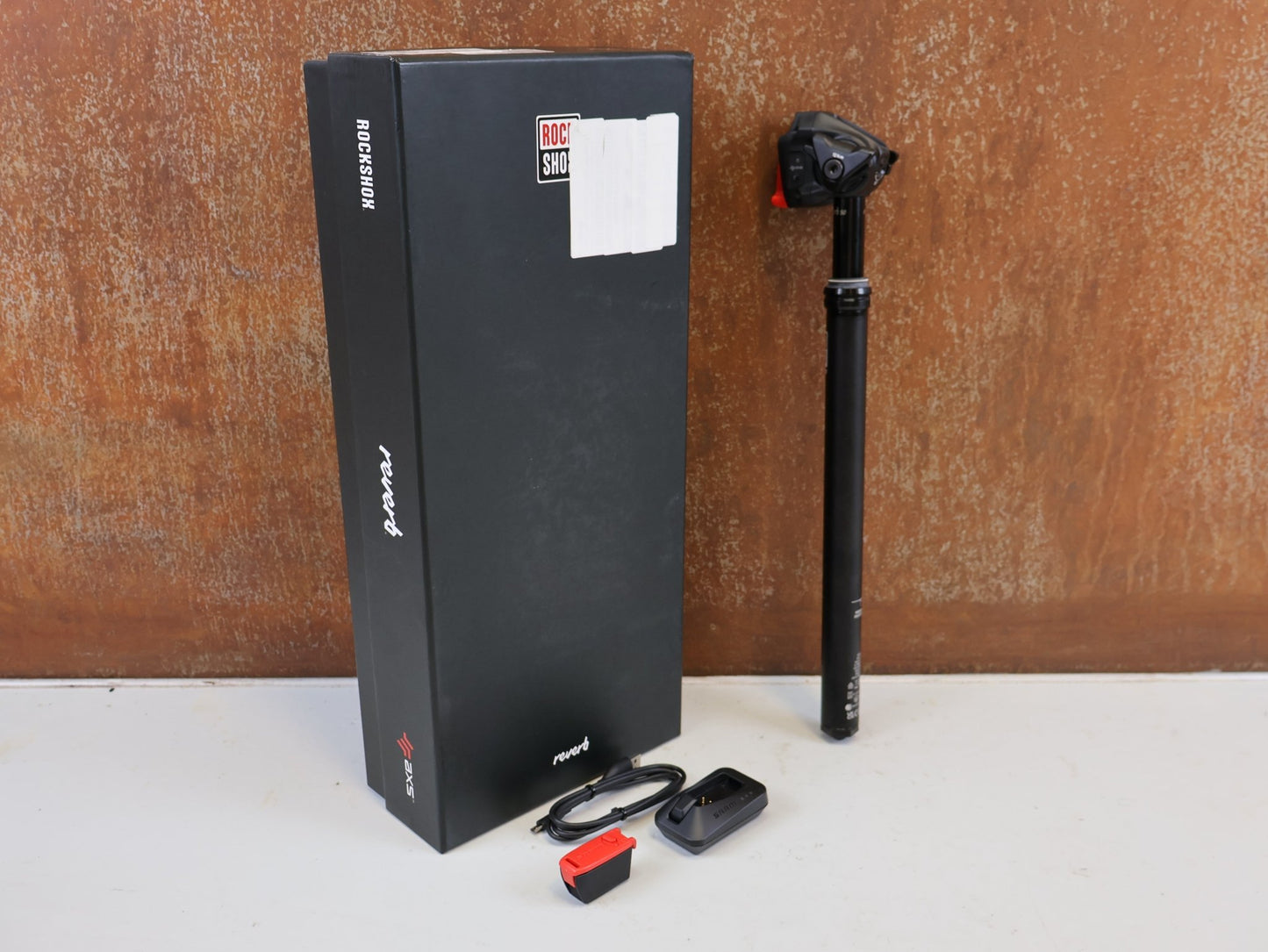 Sattelstütze von Rock Shox, ROCK SHOX REVERB AXS XPLR VARIO SATTELSTÜTZE 27.2X400 50MM vor USEDBIKES-OB.DE Hintergrund
