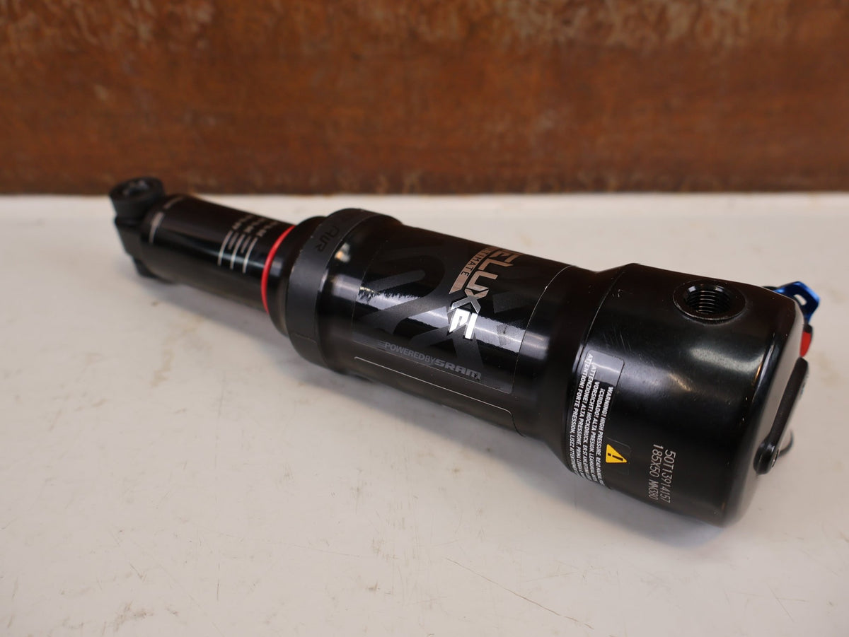 Federgabel & Dämpfer von Rock Shox, RockShox Deluxe Ultimate RCT DebonAir Trunnion 185x50 Dämpfer vor USEDBIKES-OB.DE Hintergrund