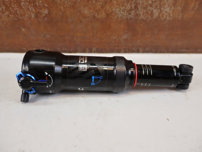 Federgabel & Dämpfer von Rock Shox, RockShox Deluxe Ultimate RCT DebonAir Trunnion 185x50 Dämpfer vor USEDBIKES-OB.DE Hintergrund