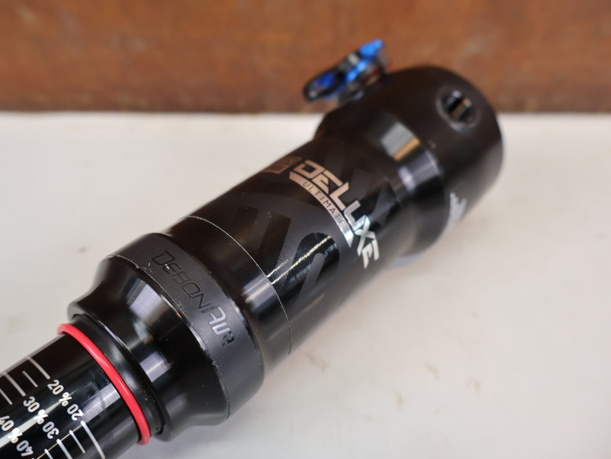Federgabel & Dämpfer von Rock Shox, RockShox Deluxe Ultimate RCT DebonAir Trunnion 185x50 Dämpfer vor USEDBIKES-OB.DE Hintergrund