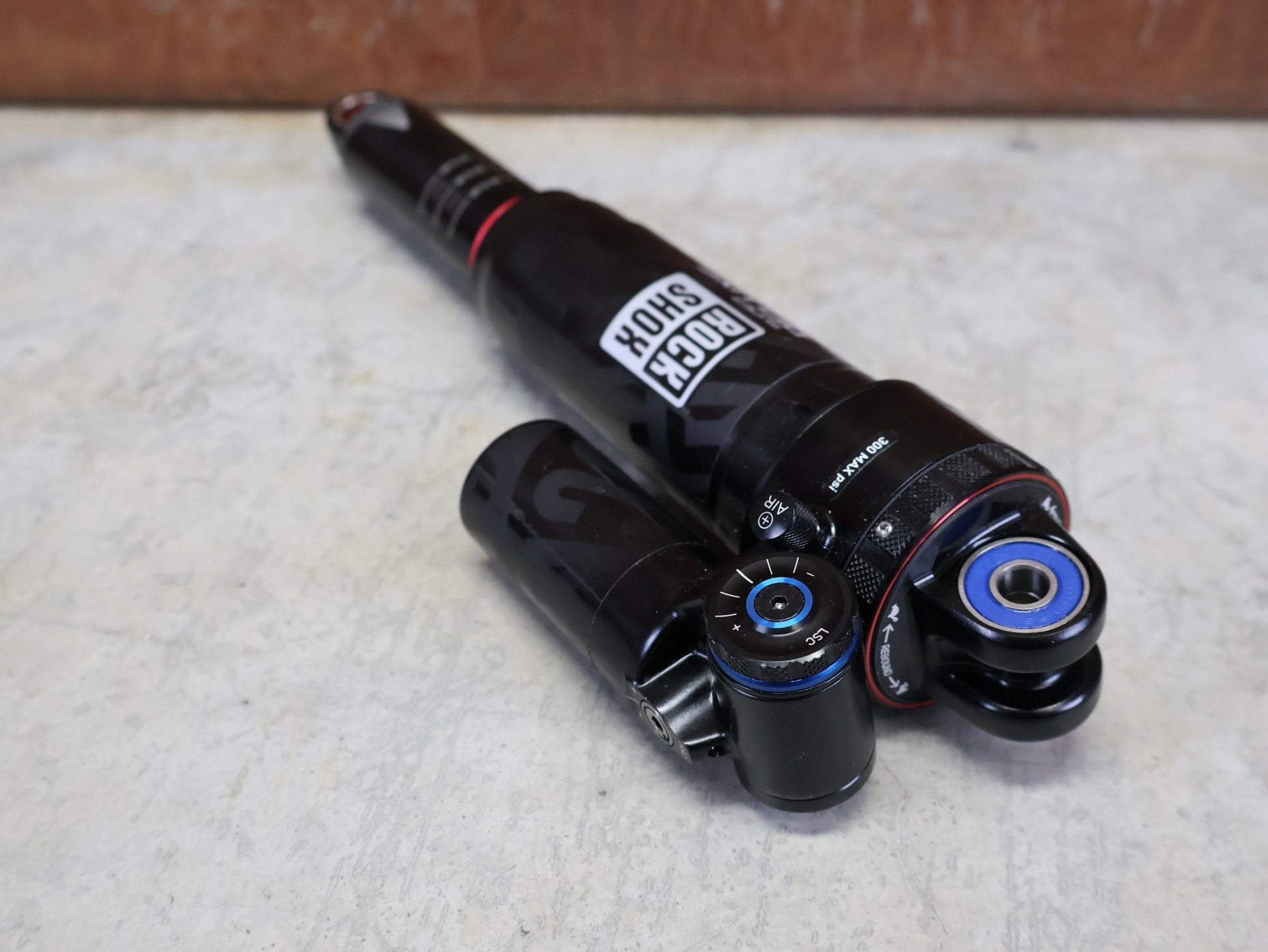 Federgabel & Dämpfer von Rock Shox, ROCKSHOX SUPER DELUXE ULTIMATE DH DÄMPFER 250X75 MM – DEBONAIR vor USEDBIKES - OB.DE Hintergrund