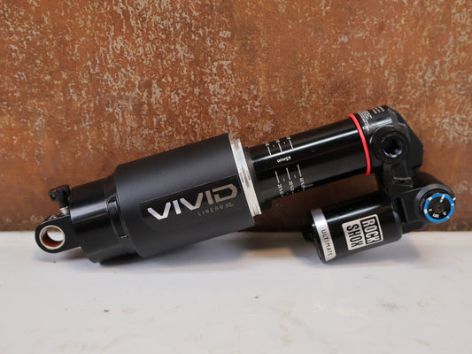 Federgabel & Dämpfer von Rock Shox, RockShox Vivid Ultimate Air Dämpfer 205x65mm Trunnion RC2T vor USEDBIKES-OB.DE Hintergrund