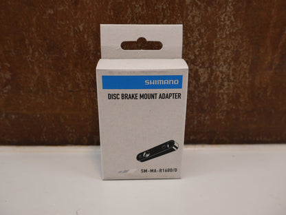 Bremsadapter von Shimano, SHIMANO ADAPTER SM-MA-R160D/D / FLATMOUNT RAHMEN AUF FLATMOUNT SATTEL / HR 160 MM vor USEDBIKES-OB.DE Hintergrund