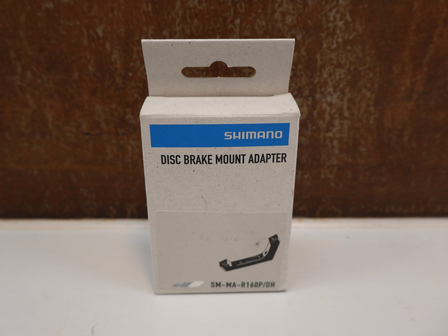 Bremsadapter von Shimano, SHIMANO ADAPTER SM-MA-R160P/D / FLATMOUNT RAHMEN AUF PM SATTEL / HR 160 MM vor USEDBIKES-OB.DE Hintergrund