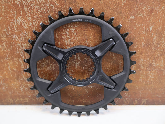 Kettenblatt von Shimano, SHIMANO DEORE XT KETTENBLATT SM-CRM85 / 34 ZÄHNE / 1X12-FACH / DIRECT MOUNT / FC-M8100-1/ M8130-1 vor USEDBIKES-OB.DE Hintergrund