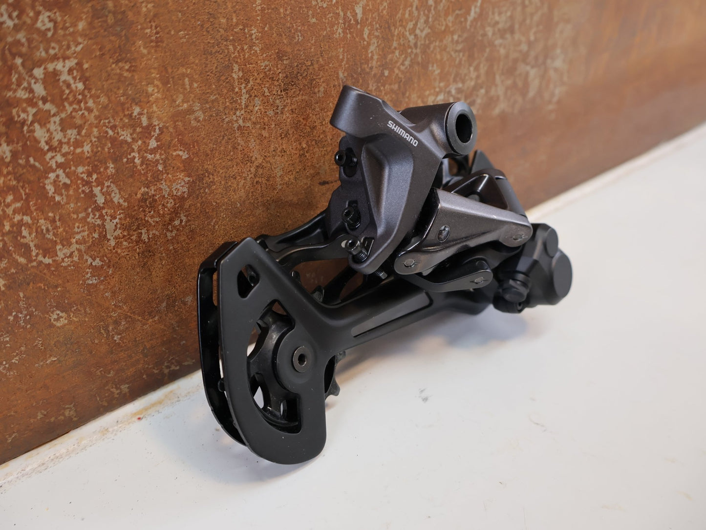Schaltungsteile von Shimano, SHIMANO DEORE XT RD-M8120 / SCHALTWERK / 2X12-FACH / LONG CAGE vor USEDBIKES-OB.DE Hintergrund
