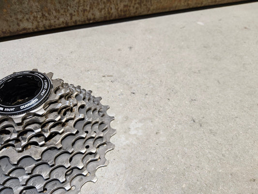 Kassette & Zahnkränze von Shimano, SHIMANO DURA ACE KASSETTE CS - R9100 11 - 28 ZAHNKRANZ vor USEDBIKES - OB.DE Hintergrund