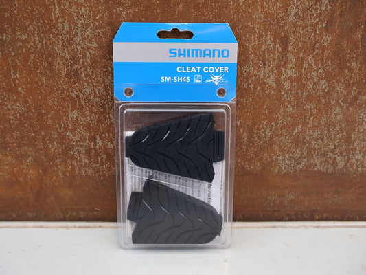 Pedale von Shimano, SHIMANO SM-SH45 CLEAT COVER SCHUHPLATTEN ABDECKUNG SPD-SL / ESMSH45 vor USEDBIKES-OB.DE Hintergrund