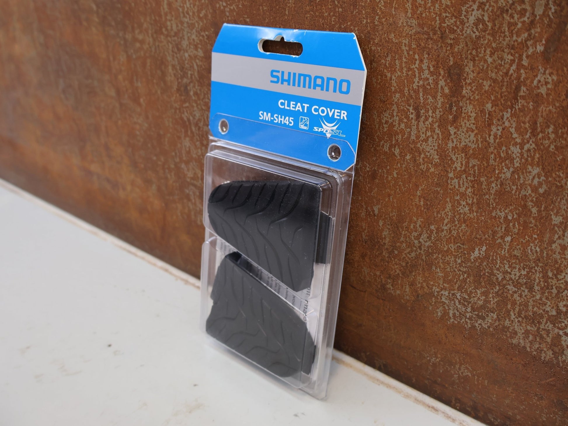 Pedale von Shimano, SHIMANO SM-SH45 CLEAT COVER SCHUHPLATTEN ABDECKUNG SPD-SL / ESMSH45 vor USEDBIKES-OB.DE Hintergrund