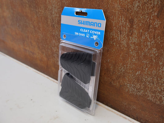 Pedale von Shimano, SHIMANO SM-SH45 CLEAT COVER SCHUHPLATTEN ABDECKUNG SPD-SL / ESMSH45 vor USEDBIKES-OB.DE Hintergrund