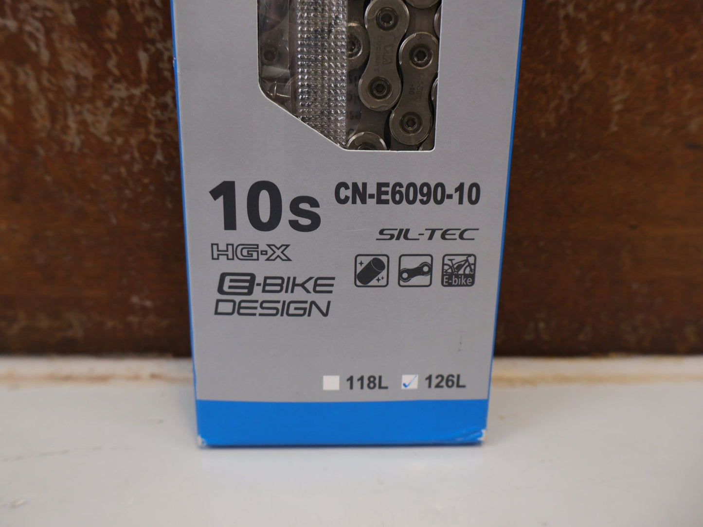 Kette von Shimano, SHIMANO STEPS CN-E6090-10 KETTE / 10-FACH 126 GLIEDER E-BIKE HG-X SIL-TEC vor USEDBIKES-OB.DE Hintergrund