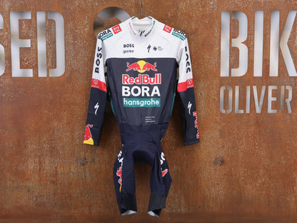 Anzug - BOH von Specialized, Specialized Red Bull BORA Cyclocross Skinsuit Long Sleeve vor USEDBIKES-OB.DE Hintergrund