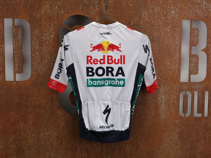 Kurzarm Trikot - BOH von Specialized, SPECIALIZED RED BULL - BORA HANSGROHE LIGHTWEIGHT JERSEY SS / KURZARM TRIKOT U23 vor USEDBIKES - OB.DE Hintergrund