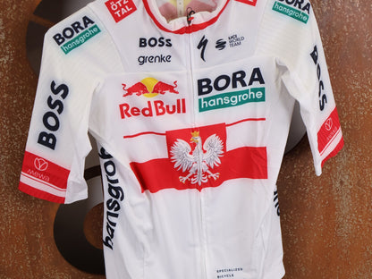 Kurzarm Trikot - BOH von Specialized, SPECIALIZED RED BULL - BORA HANSGROHE RACE JERSEY SS / POLAND CHAMPION vor USEDBIKES - OB.DE Hintergrund