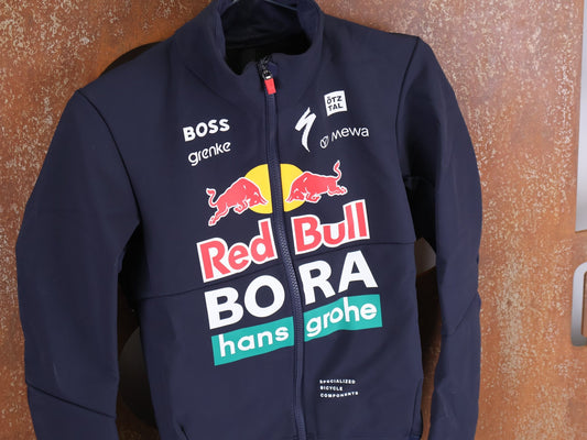 Langarm Trikot - BOH von Specialized, SPECIALIZED RED BULL - BORA HANSGROHE SOFTSHELL JACKET / WINTERJACKE vor USEDBIKES - OB.DE Hintergrund