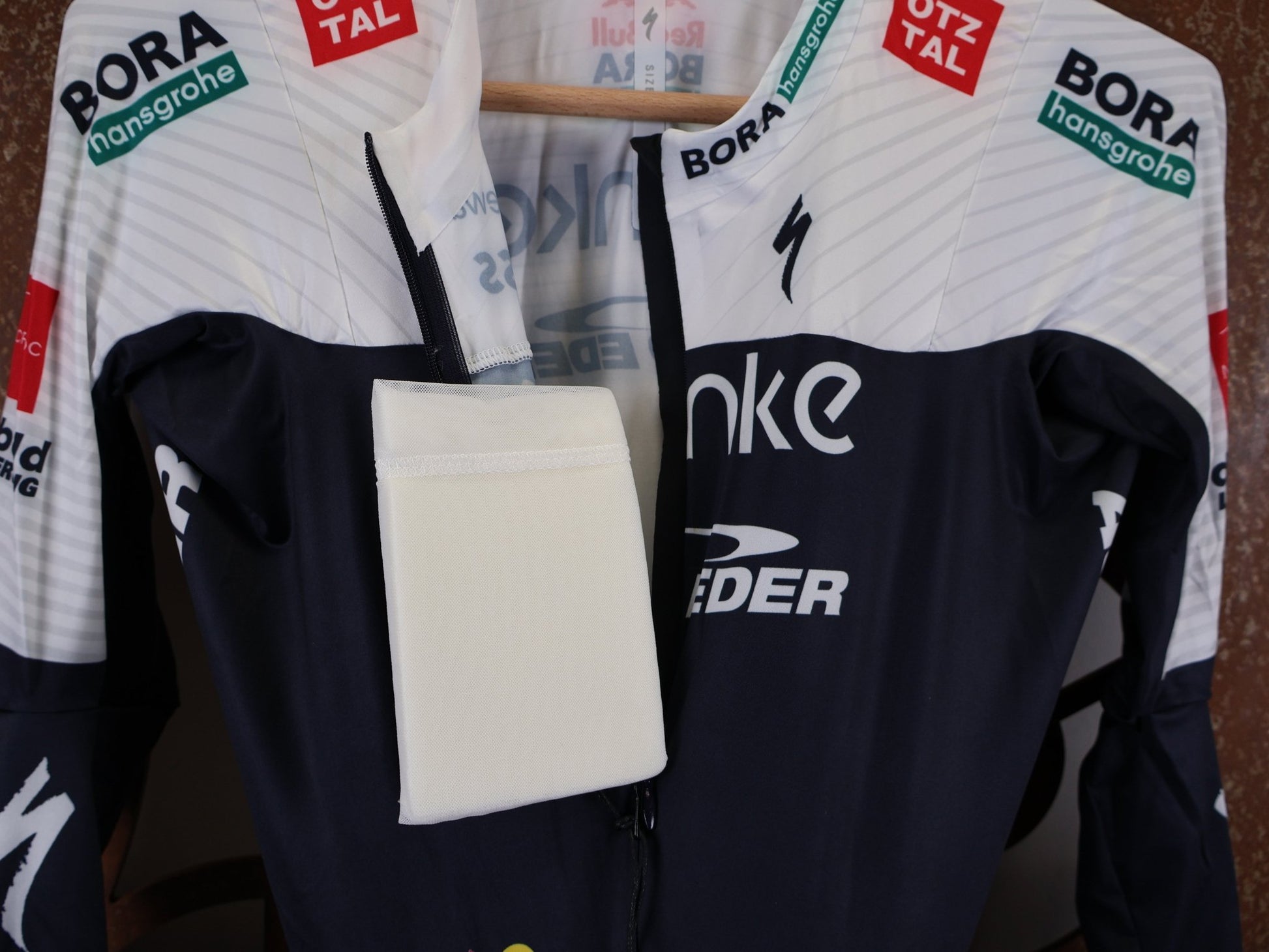 Anzug - BOH von Specialized, SPECIALIZED TGA ROOKIES OF RED BULL - BORA HANSGROHE AERO SKIN SUIT LS / LANGARM EINTEILER vor USEDBIKES - OB.DE Hintergrund