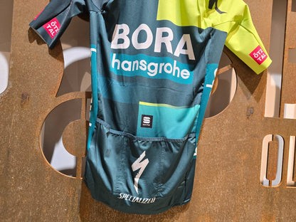 Kurzarm Trikot - BOH von Sportful, SPORTFUL BORA HANSGROHE BOMBER JERSEY / KURZARM TRIKOT in variant_title vor USEDBIKES - OB.DE Hintergrund