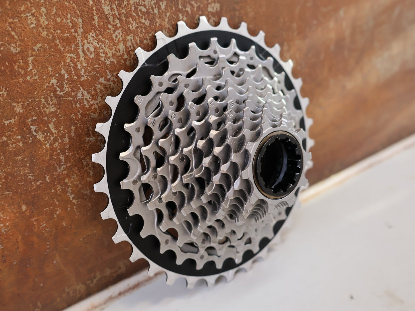 Kassette & Zahnkränze von Sram, SRAM FORCE XG 1270 E1 KASSETTE ZAHNKRANZ 10-33 ZÄHNE vor USEDBIKES-OB.DE Hintergrund