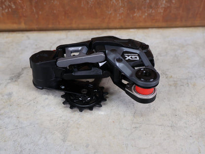 Schaltungsteile von Sram, SRAM GX EAGLE TRANSMISSION SCHALTWERK / 12 - FACH – T - TYPE – UDH vor USEDBIKES - OB.DE Hintergrund