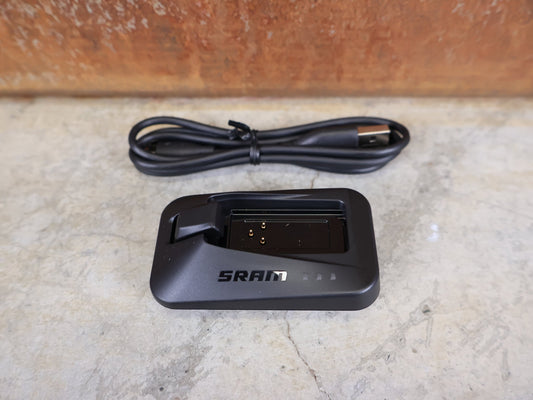 Zubehör von Sram, SRAM LADEGERÄT FÜR EAGLE / RED / FORCE / RIVAL / REVERB AXS & RED ETAP vor USEDBIKES - OB.DE Hintergrund