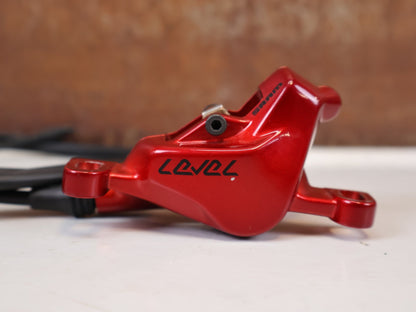 Bremse von Sram, SRAM Level Ultimate Bremsen Set Red Nino Schurter vor USEDBIKES-OB.DE Hintergrund