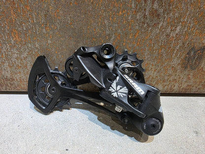 Schaltungsteile von Sram, SRAM NX EAGLE SCHALTWERK 12 FACH vor USEDBIKES - OB.DE Hintergrund