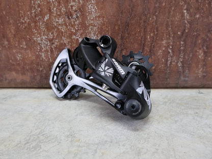 Schaltungsteile von Sram, SRAM NX EAGLE SCHALTWERK 12 FACH vor USEDBIKES - OB.DE Hintergrund