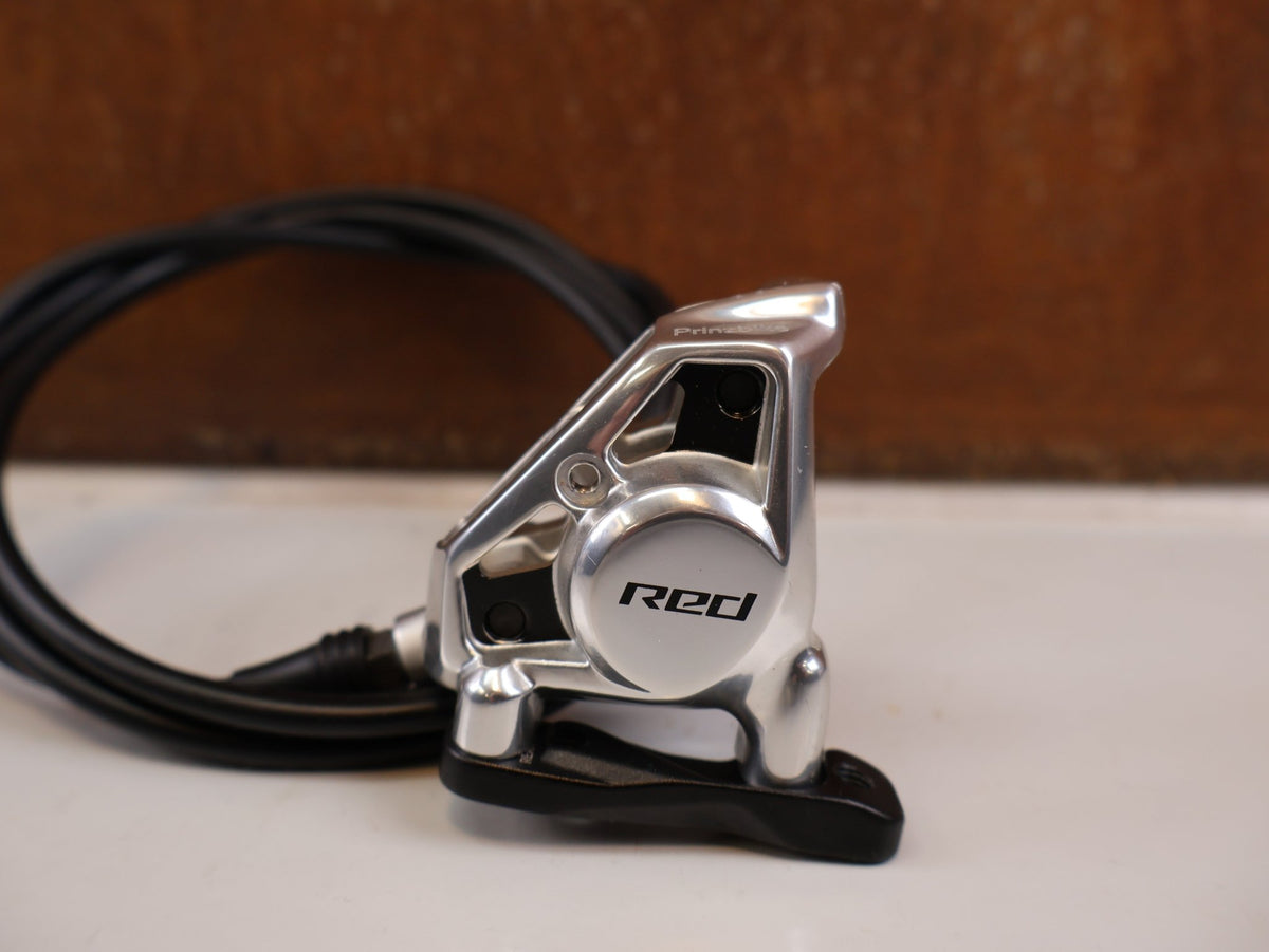 Brems-/ Schalthebel von Sram, SRAM RED AXS E1 Schalt Bremshebel Set Flatmount vor USEDBIKES-OB.DE Hintergrund