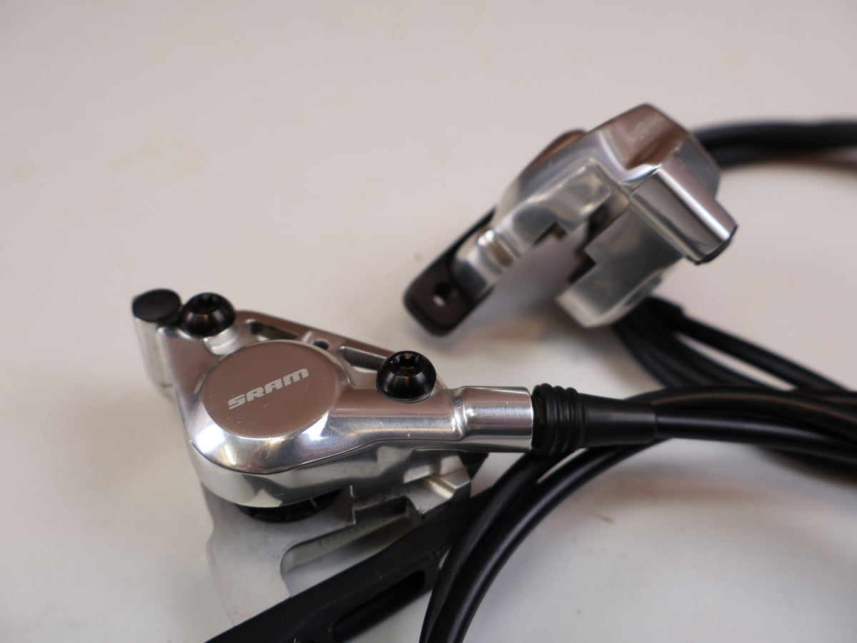 Brems-/ Schalthebel von Sram, SRAM RED AXS E1 Schalt Bremshebel Set Flatmount vor USEDBIKES-OB.DE Hintergrund